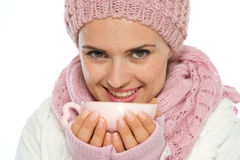woman-winter-clothing-holding-cup-tea-27812879